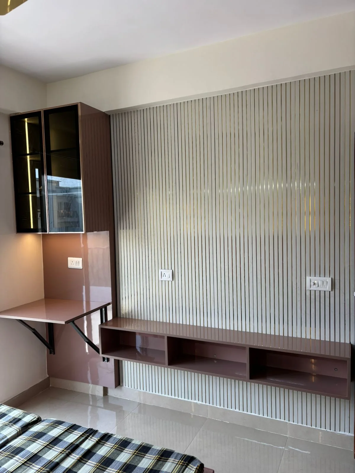 Bedroom wall unit with slim fluted paneling, floating storage and fold-down study desk