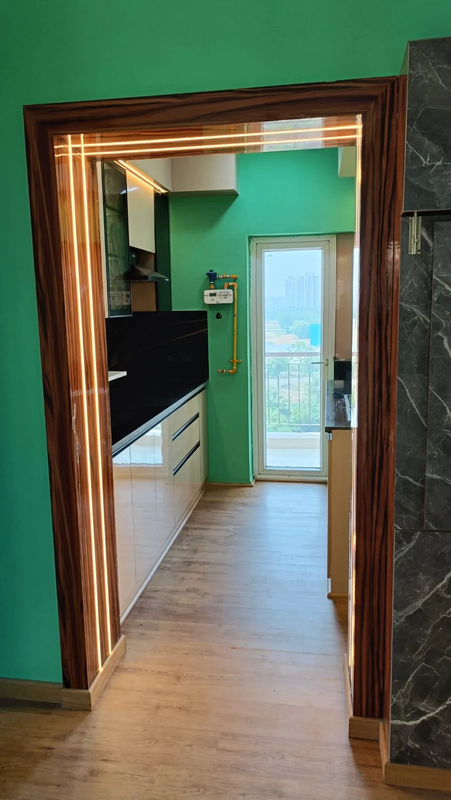 Custom glossy wood doorway frame with continuous integrated warm LED lighting