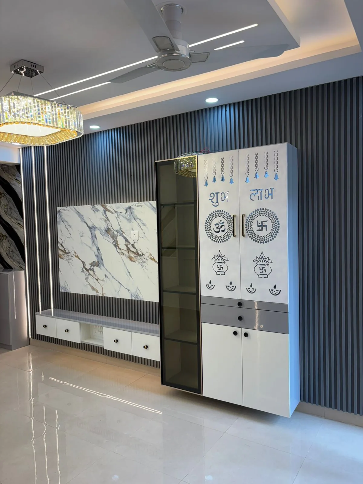 White and charcoal feature wall with vertical slats, custom pooja cabinet and floating TV storage